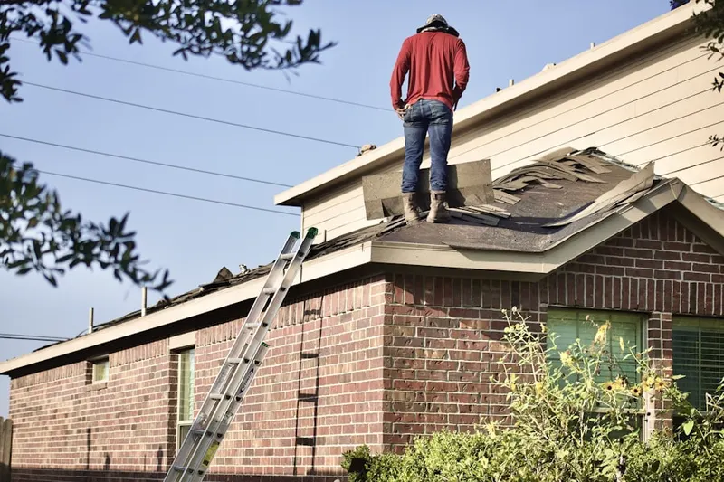 Professional roofer working on a residential roof in Old Towne